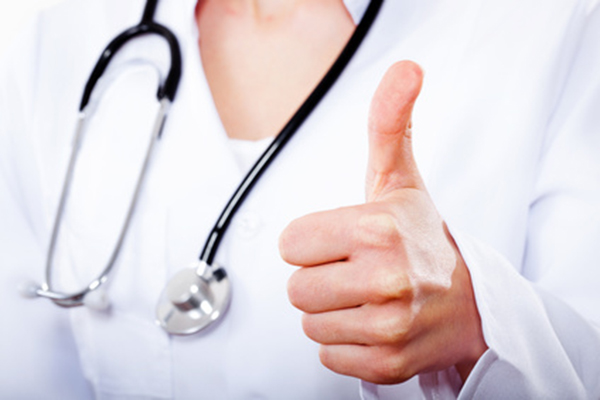 female doctor with thumbs up gesture.